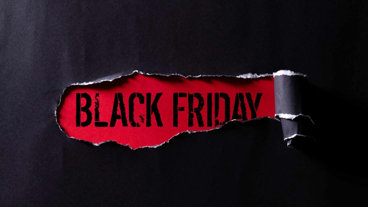 Top view of Black torn paper and the text black friday on a red