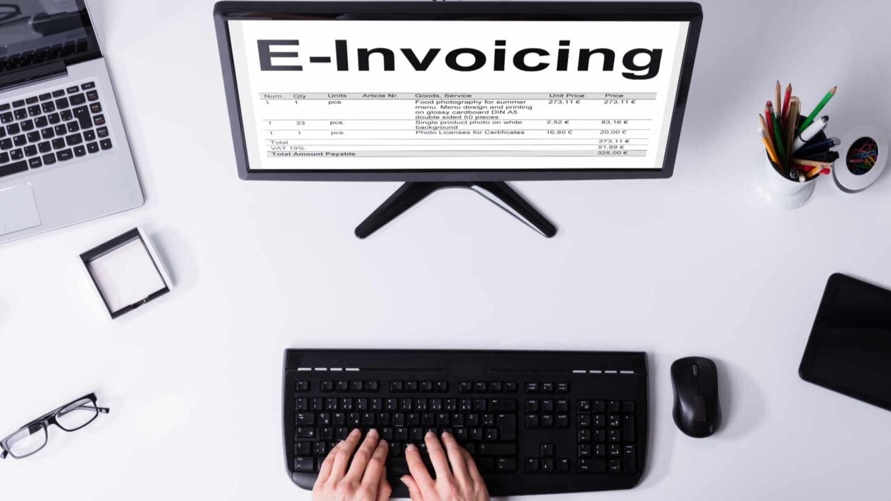 Businessperson Preparing E-invoicing Bill On Computer